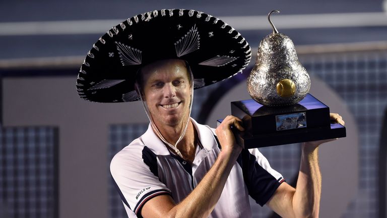 Sam Querrey of the US celebrates with the trophy after beating Rafael Nadal of Spain 6-3, 7-6 (7/3) in the ATP men's singles finals of the Mexican Tennis O