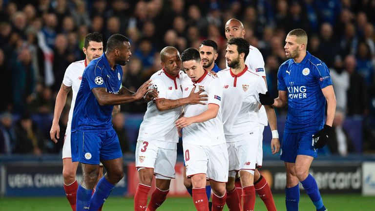 Sevilla's French forward Samir Nasri (C) is sheperded by other players as he reacts after being sent off following an off-the-ball incident with Leicester 