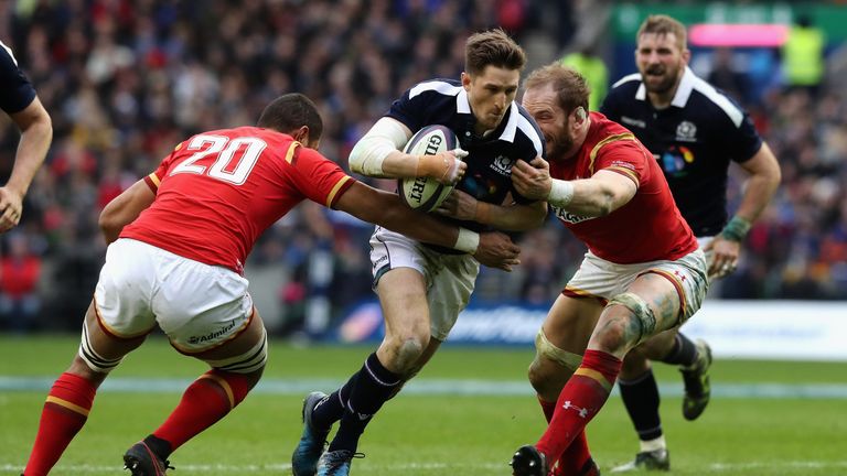 EDINBURGH, SCOTLAND - FEBRUARY 25 2017:  Henry Pyrgos of Scotland is held by Taulupe Faletau (L) and Alun Wyn Jones of Wales during the Six Nations