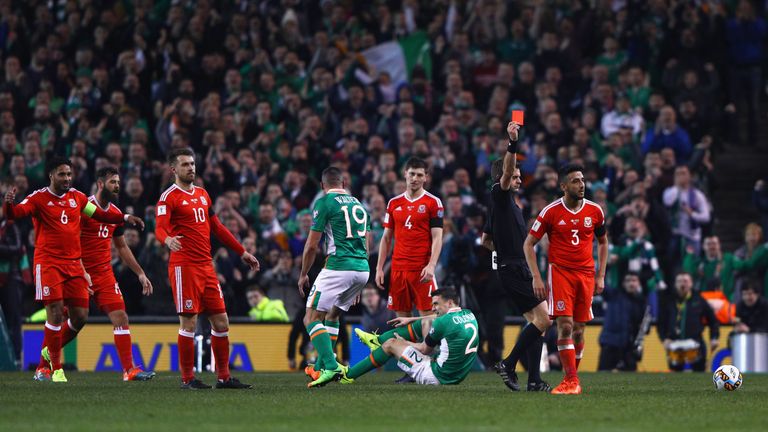  Players react as Neil Taylor of Wales (3) is shown a red card by referee Nicola Rizzoli and is sent off after a challenge on Seamus Coleman