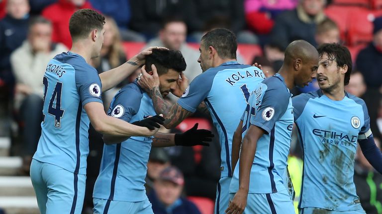 Manchester City's Argentinian striker Sergio Aguero (2nd L) celebrates with teammates after scoring the opening goal of the English Premier League football