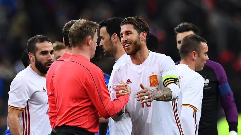 Spain's defender Sergio Ramos (R) skahes hands with a referee at the end of the friendly football match France vs Spain on March 28, 2017 at the Stade de F