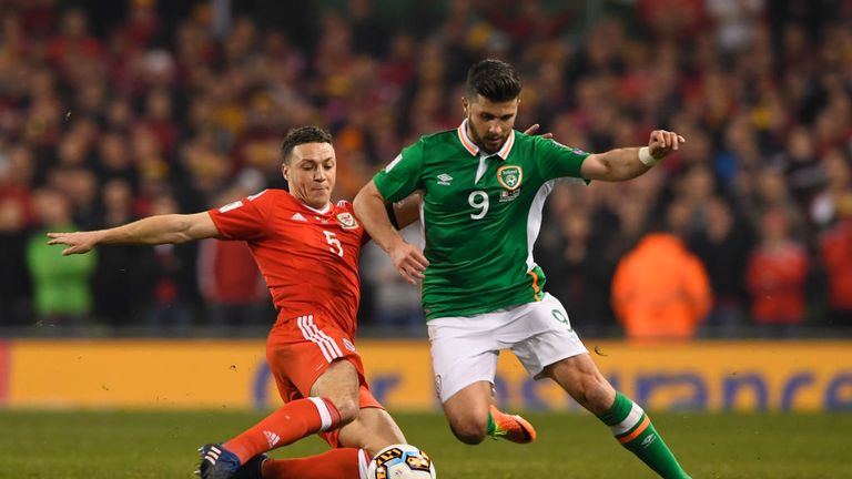 DUBLIN, IRELAND - MARCH 24:  James Chester of Wales stretches to tackle Shane Long of the Republic of Ireland during the FIFA 2018 World Cup Qualifier betw