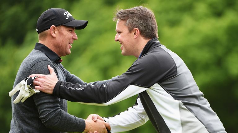 VIRGINIA WATER, ENGLAND - MAY 25: Former cricketers Shane Warne and Graeme Swann shake hands during the Pro-Am prior to the BMW PGA Championship at Wentwor