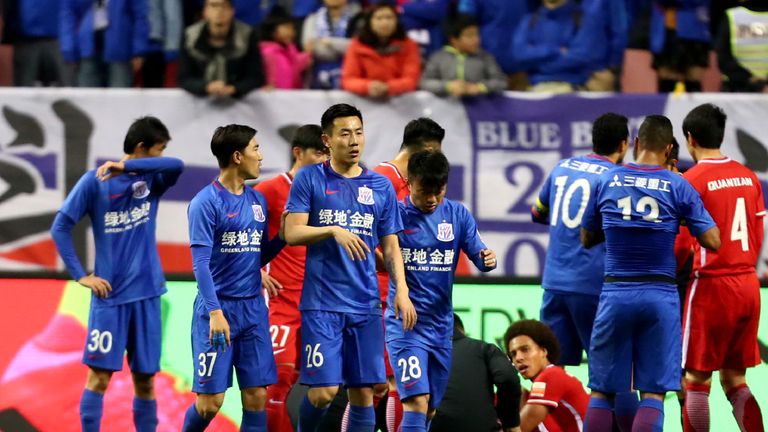 This photo taken on March 11, 2017 shows Shanghai Shenhua's Qin Sheng (26) leaving the pitch after being given a red card during the Chinese Super League m