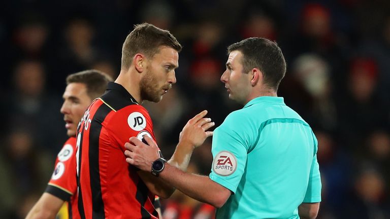 Bournemouth captain Simon Francis in conversation with referee Michael Oliver