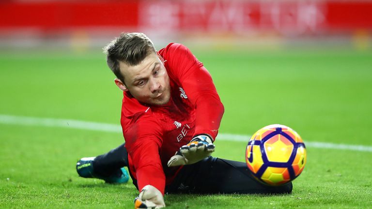Simon Mignolet warms up prior to the Premier League match between Liverpool and Manchester City at Anfield