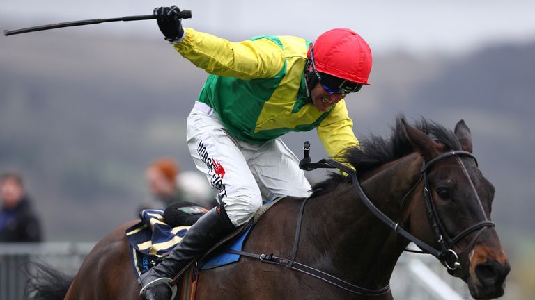 CHELTENHAM, ENGLAND - MARCH 17:  Sizing John is steered to victory by Robbie Power in the Timico Cheltenham Gold Cup Chase during Gold Cup Day on day four 