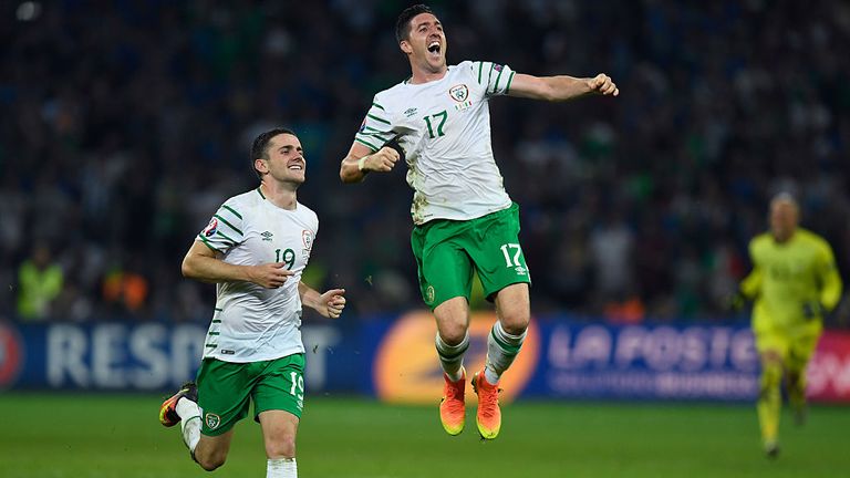 Stephen Ward (airborne) and Robbie Brady celebrate victory over Italy at Euro 2016 