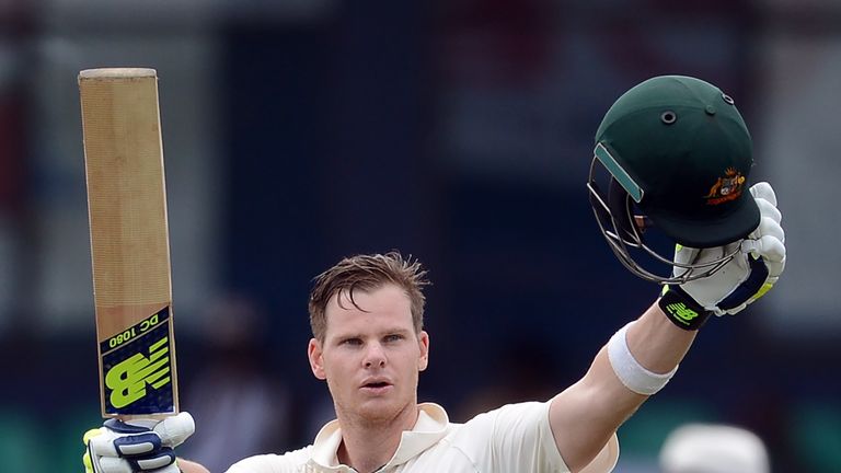 Australia's captain Steven Smith raises his bat and helmet in celebration after scoring a century in Sri Lanka