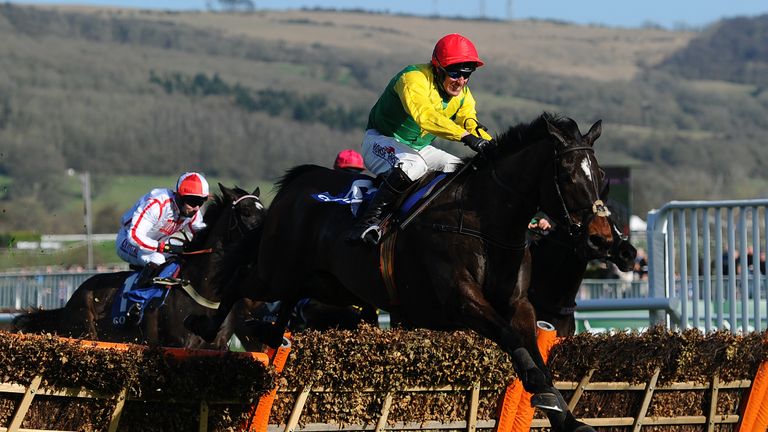 CHELTENHAM, UNITED KINGDOM - MARCH 15: Supasundae ridden by Robbie Power jump the last to win the Coral Cup Handicap Hurdle during Ladies Day of the Chelte