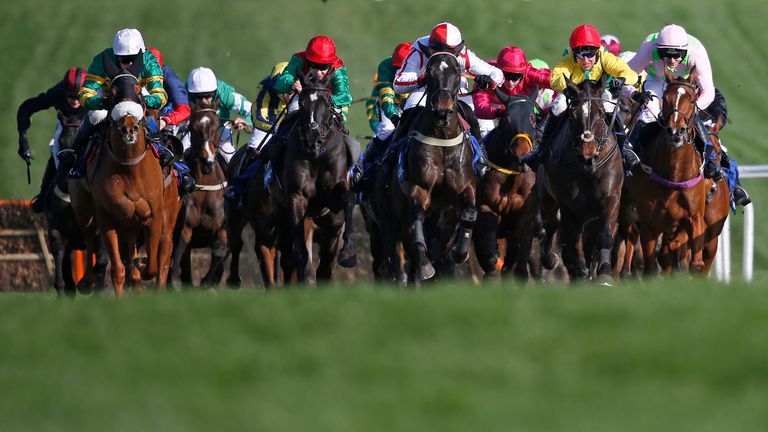 CHELTENHAM, ENGLAND - MARCH 15: Robbie Power riding Supasundae (R, yellow/red cap) clear the second last before winning The Coral Cup Handicap Hurdle Race 