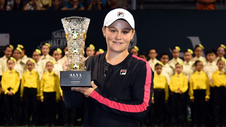 Ashleigh Barty of Australia poses with the WTA Malaysian Open Champion Trophy after she defeated Nao Hibino