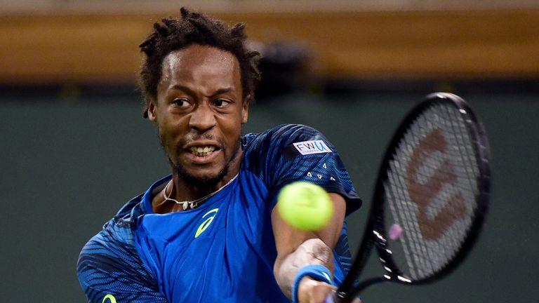 Gael Monfils of France returns a backhand in his match against John Isner during the BNP Paribas Open at Indian Wells Tennis 