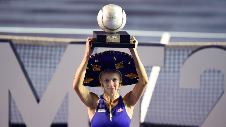 Ukranian tennis player Lesia Tsurenko holds up the trophy after winning the Mexican Tennis Open WTA final match against French Kristina Mladenovic
