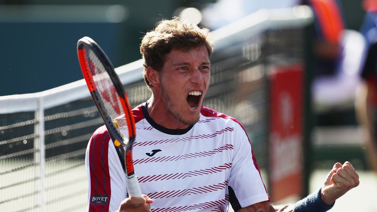 Pablo Carreno Busta of Spain celebrates match point against Pablo Cuevas of Uruguay in their quarter final  match