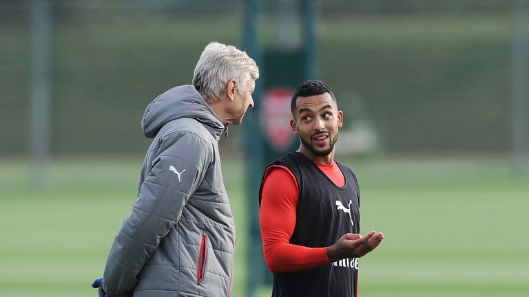 Arsene Wenger talks with Theo Walcott during a training session at London Colney