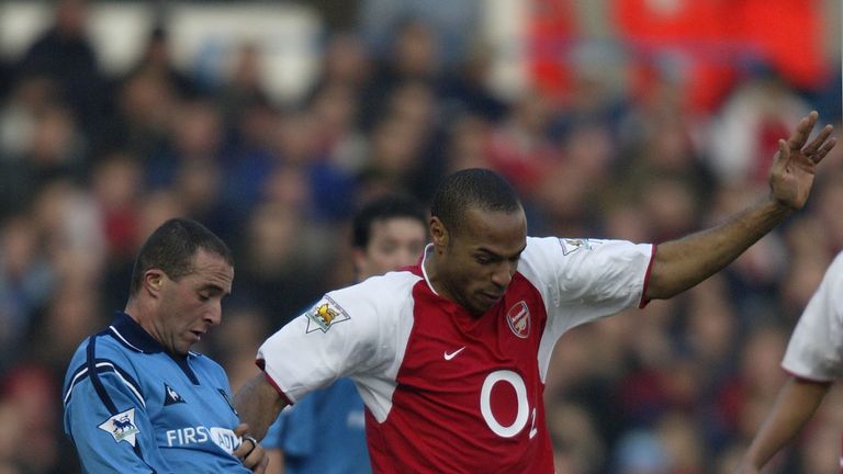 MANCHESTER - FEBRUARY 22:  Djamel Belmadi of Manchester City tackles Thierry Henry of Arsenal during the Barclaycard Premiership match between Manchester C