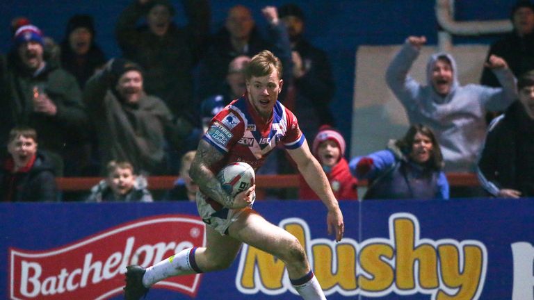  Wakefield's Tom Johnstone runs in for a try.