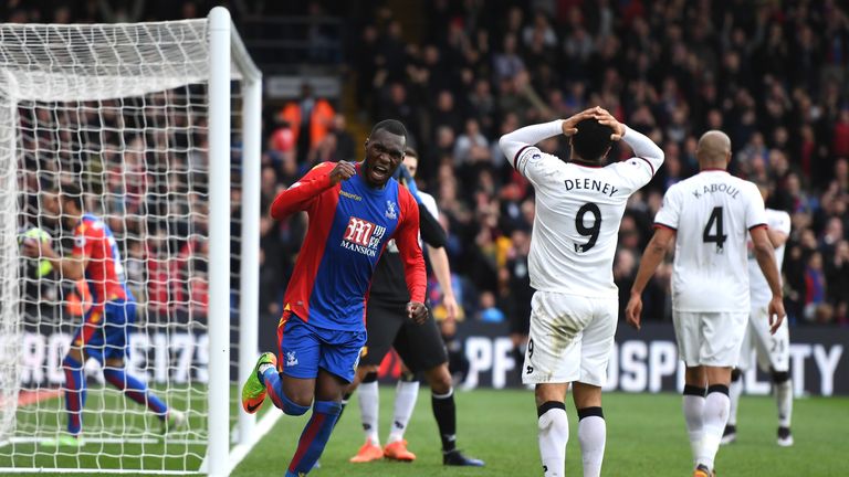 LONDON, ENGLAND - MARCH 18:  Christian Benteke of Crystal Palace (L) celebrates after Troy Deeney of Watford (R) scores a own goal for Crystal Palace first