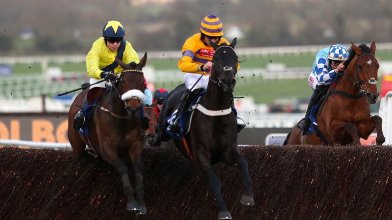 Tully East (left) leads Gold Present over the last in the Close Brothers Novices' Handicap Chase at Cheltenham