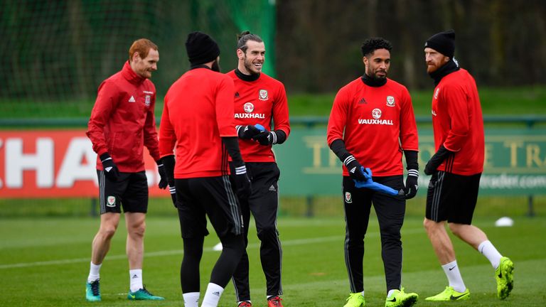 Gareth Bale  shares a joke with team-mates during an open training session