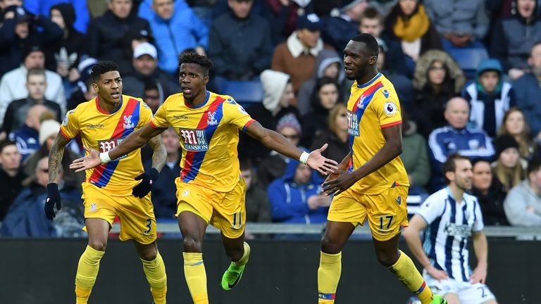 Crystal Palace's Ivorian-born English striker Wilfried Zaha (2nd L) celebrates after scoring the opening goal of the English Premier League football match 