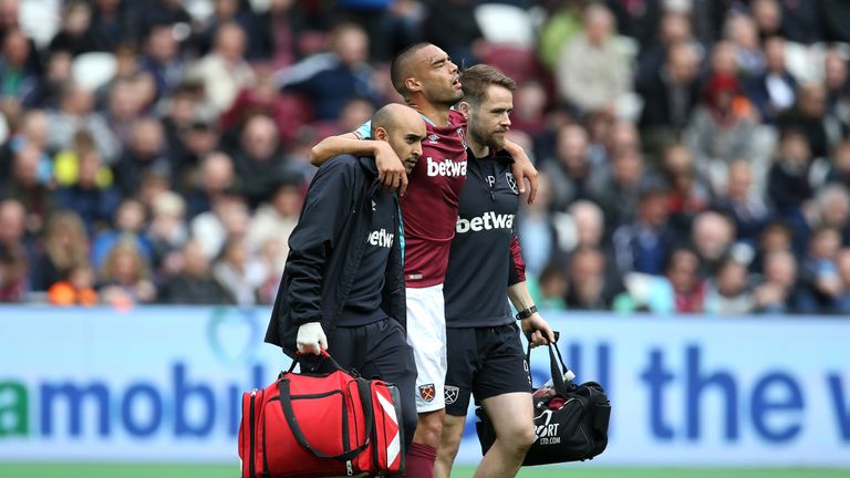 Winston Reid is given assistance in walking off the pitch following an injury during the game against Leicester City