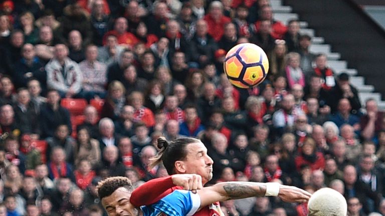Bournemouth's English defender Tyrone Mings (L) is hurt contesting a header with Manchester United's Swedish striker Zlatan Ibrahimovic during the English 
