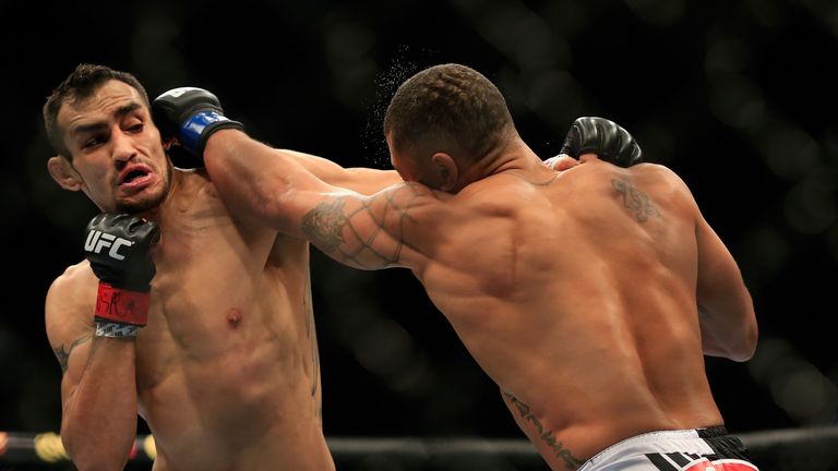 LAS VEGAS, NV - DECEMBER 06:  Abel Trujillo punches Tony Ferguson in their fight during the UFC 181 event at the Mandalay Bay Events Center on December 6, 