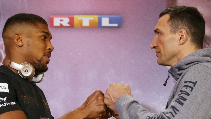 Britain's Anthony Joshua (L) poses by Ukraine's Wladimir Klitschko during a joint press conference at Sky broadcasting headquarters in west London on April