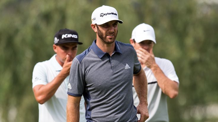 Rickie Fowler of the US (L), Dustin Johnson of the US (C), and Rory McIlroy of Northern Ireland (R) consider their shots during the WGC-HSBC Champions golf