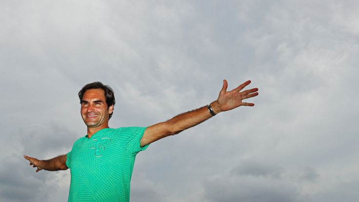 Roger Federer of Switzerland poses in front of the Miami Skyline after defeating  Rafael Nadal of Spain