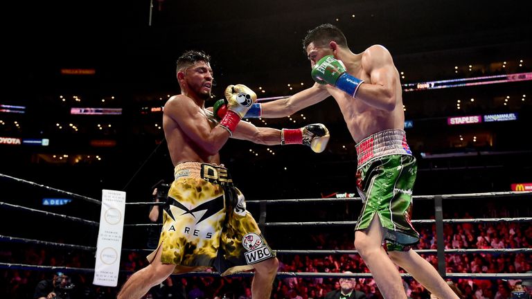 LOS ANGELES, CA - AUGUST 29:  Leo Santa Cruz punches Abner Mares of Mexico during the seventh round of the WBC diamond featherweight and WBA featherweight 