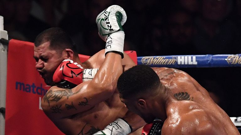 TOPSHOT - England's Anthony Joshua (R) delivers the winning punch against  USA's Eric Molina during the IBF World Heavyweight Championship boxing match in 