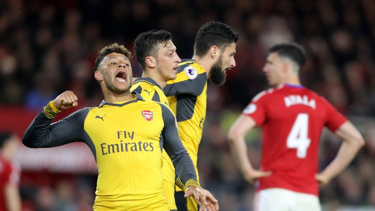 Arsenal's Mesut Ozil (second left)celebrates scoring his side's second goal of the game alongside Alex Oxlade-Chamberlain during the Premier League match a