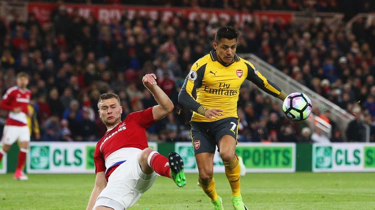 MIDDLESBROUGH, ENGLAND - APRIL 17:  Alexis Sanchez of Arsenal is challenged by Ben Gibson of Middlesbrough during the Premier League match between Middlesb