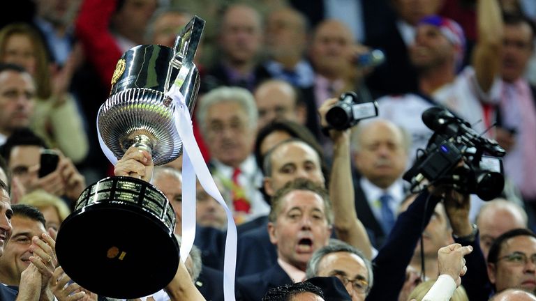 Sevilla's captain goalkeeper Andres Palop celebrates with the trophy after winning the King's Cup final match against Atletico Madrid at the Camp Nou stadi