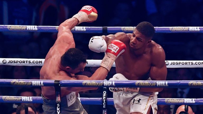 Britain's Anthony Joshua (R) throws a punch at Ukraine's Wladimir Klitschko during the ninth round of their IBF, IBO and WBA, world Heavyweight title fight