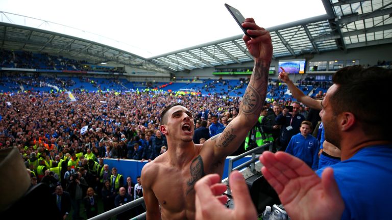 BRIGHTON, ENGLAND - APRIL 17:  Anthony Knockaert of Brighton & Hove Albion celebrates with team-mates in the stands after victory in the Sky Bet Championsh
