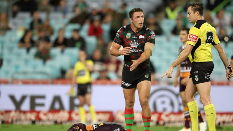 SYDNEY, AUSTRALIA - APRIL 21:  Anthony Milford of the Broncos lies injured on the ground as Sam Burgess of the Rabbitohs appeals the the referee during the