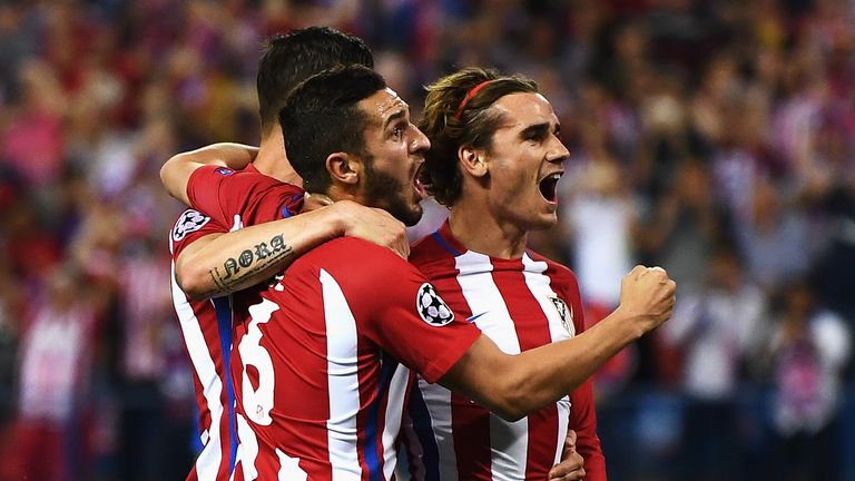 Antoine Griezmann celebrates with team-mates after giving Atletico the lead from the penalty spot