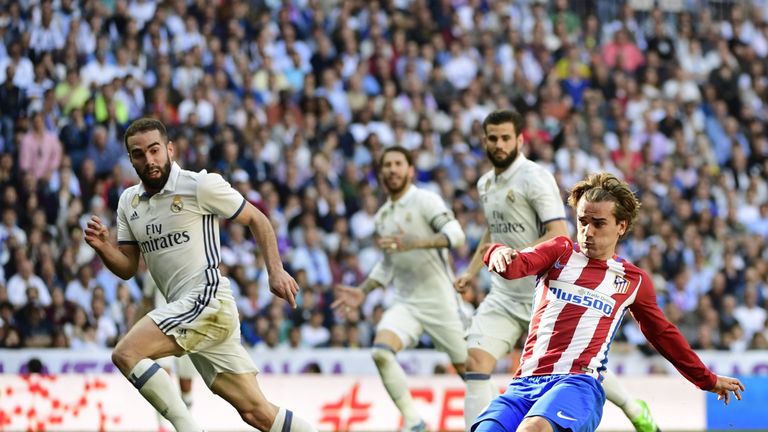 Atletico Madrid's French forward Antoine Griezmann (R) scores a goal during the Spanish league football match Real Madrid CF vs Club Atletico de Madrid at 