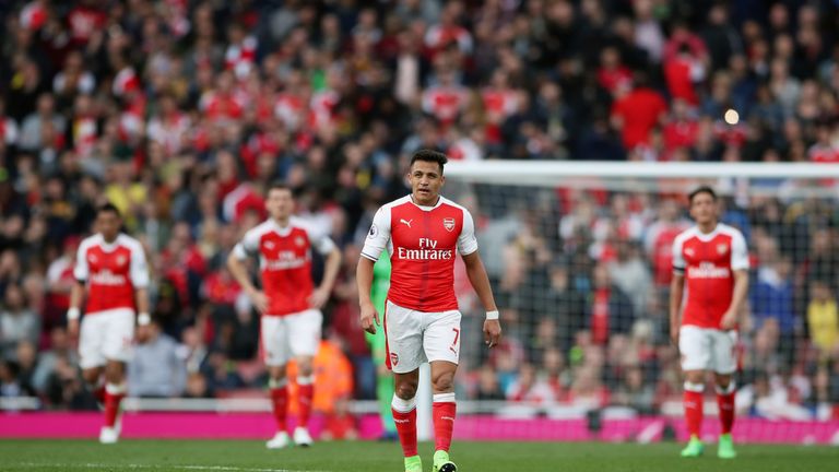Arsenal's Alexis Sanchez (centre) and team-mates stand dejected after Manchester City's Sergio Aguero (not pictured) scores his side's second goal of the g