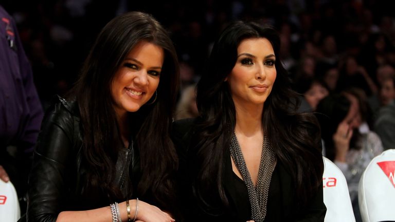 Khloe Kardashian (L) and sister Kim Kardashian are seen at an NBA basketball game between the Los Angeles Lakers