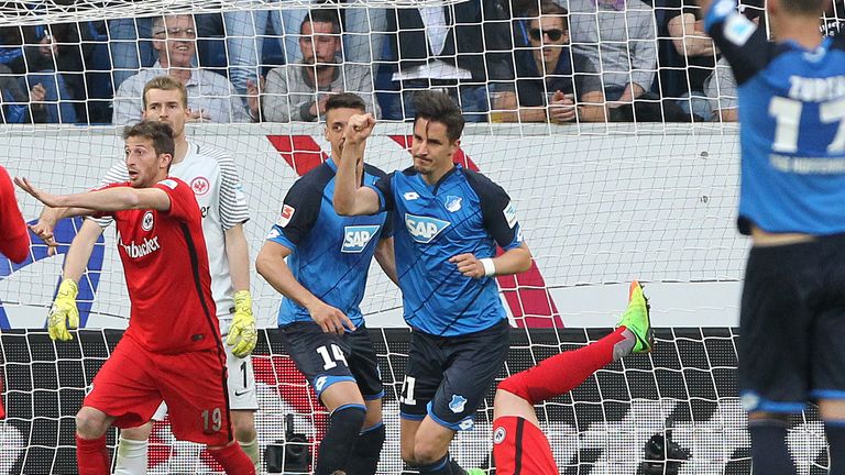 Hoffenheim's defender Benjamin Huebner (C) celebrates scoring the 1-0 during the German first division Bundesliga football match between TSG Hoffenheim and