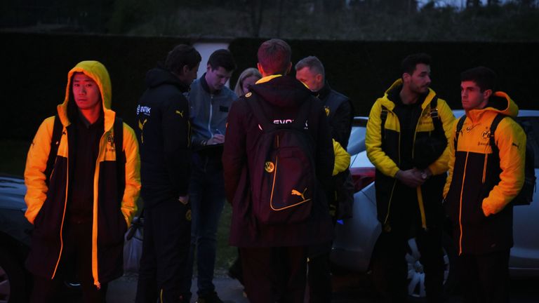 Borrusia Dortmund players wait after their team bus was damaged by three explosions