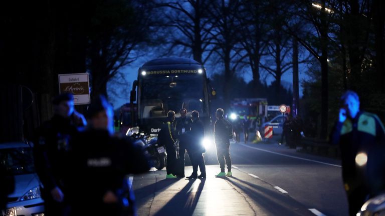 Borussia Dortmund head coach Thomas Tuchel stands near the team bus after it was damaged by an explosion