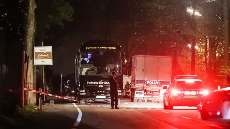 Police stand near the team bus of the Borussia Dortmund football club after the bus was damaged in an explosion on April 11, 2017