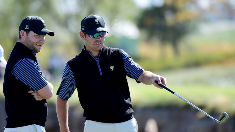 INCHEON CITY, SOUTH KOREA - OCTOBER 09:  (L-R) Branden Grace and Louis Oosthuizen of the International Team react after a putt leading to a 4 and 3 win ove